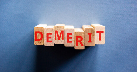 Demerit symbol. Concept word Demerit on beautiful wooden blocks. Beautiful blue background....