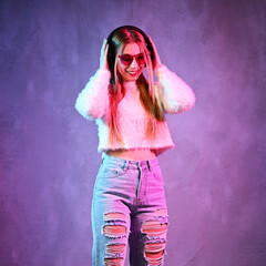 Portrait of dancing young woman with headphones