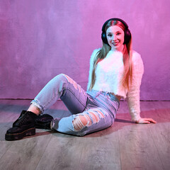 Portrait of sitting young woman with headphones