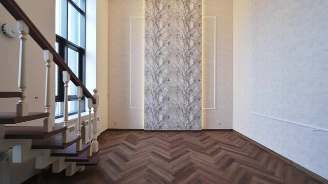 Modern interior with floating staircase, herringbone parquet floor, textured accent wall, large windows, neutral tones &mdash; sleek and spacious design.
