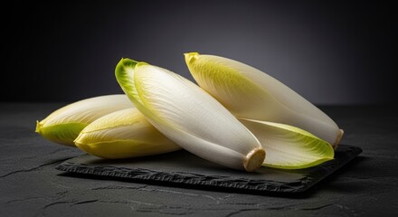 Fresh endive chicory heads on dark slate background