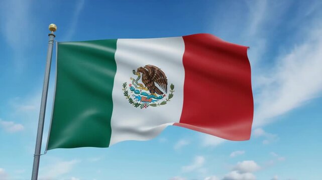 Mexican flag waving in the wind against a clear blue sky