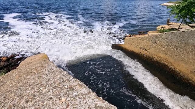 The Khadzhibey Estuary, Polluted water from a pipe from the "Irrigation Field" flows into the estuary