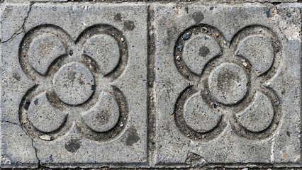 Grey concrete pavement texture with relief pattern background.