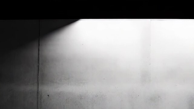 Empty concrete room featuring grunge textured wall and floor surfaces with strong gradient lighting, creating a minimalist industrial background or stage for product display
