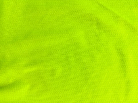 Top view of neon green fabric texture background