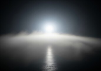 Obraz premium An ethereal light emerges from dense mist, guiding the path through a mysterious, unknown journey