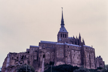 Mont Saint-Michel, Normandy, France, August 1973: close view of the medieval abbey and stone architecture dominating the tidal island