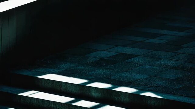 Concrete steps creating a visual rhythm with alternating bright sunlight and deep shadows, emphasizing contrast and depth, suggesting progress or an abstract pattern in urban architecture