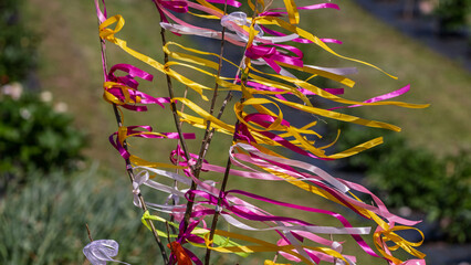 Colorful festive ribbons fluttering in the garden