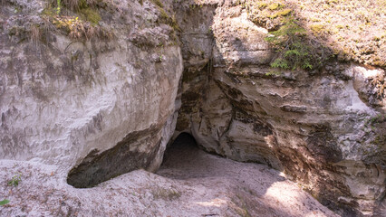 Natural cave opening in ancient sandstone cliff