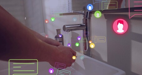 Washing adult hands under chrome faucet at bathroom sink, showing soap dispenser and messages