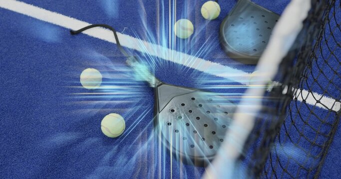 Resting center padel racket with wrist strap on blue turf near white line, balls and net