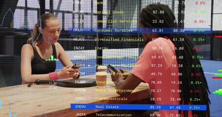 Naklejka premium Checking pair in workout gear at gym tapping phones, showing market overlay, charger, pink band