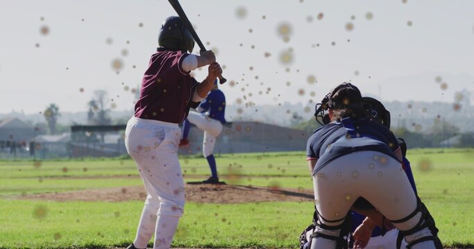 Holding bat, female batter in maroon jersey preparing swing at home plate, with catcher in gear