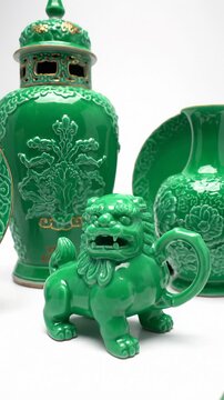 Collection of Green Ceramic Chinese Foo Dog and Vases Displayed on White Background