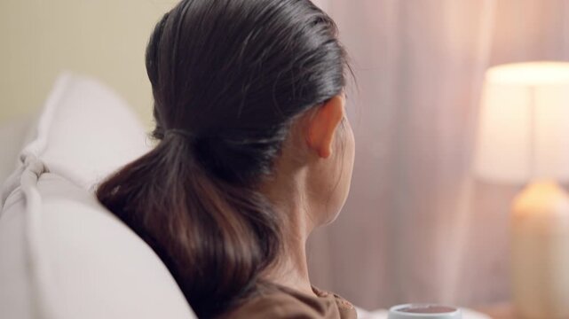 Mother pumping breast milk at home while baby naps. Reflects real motherhood, multitasking, and nurturing.