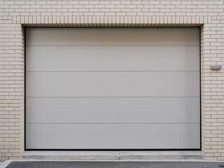 Modern garage door set in a light brick wall building