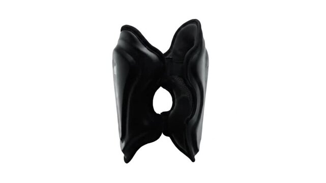 Modern Leg Guards: A black shin guard, sculpted with intricate contours and designed for optimal protection, stands as a testament to the pursuit of peak athletic performance.