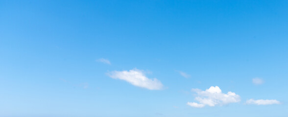 Fototapeta premium Blue Sky Background with White Clouds on Right Side and Wide Copy Space
