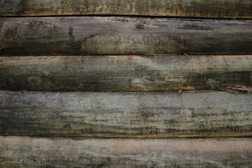 beautiful natural wooden logs stacked in a row	
