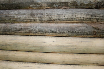beautiful natural wooden logs stacked in a row	
