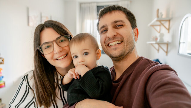 Happy family with baby enjoying time at home