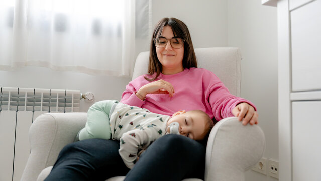 Mother sitting with baby at home during family time