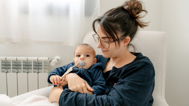 Mother bonding with baby during family time at home