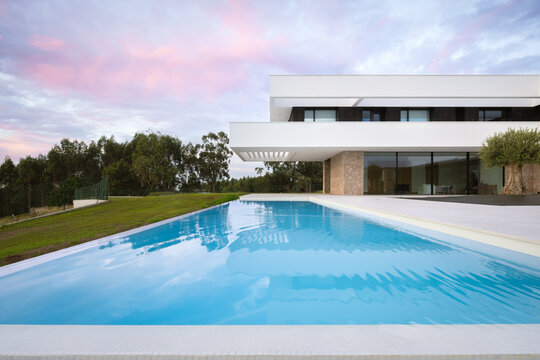 Modern house with pool under a twilight sky