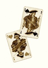 A pair of vintage playing cards of the same value in sepia on a white background.