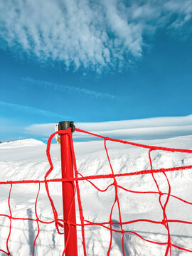 Snowy mountain landscape with ski trail barrier