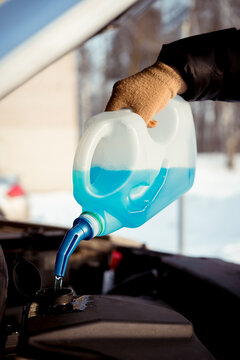 Winter windshield washer liquid in use for car maintenance