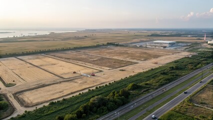 Obraz premium Aerial View of Industrial Land Development Near Transportation Hub