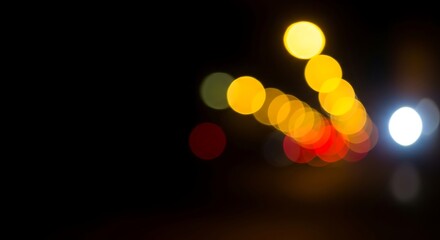 Fototapeta premium Abstract Light Bokeh Effect with Yellow and White Glows on Dark Background