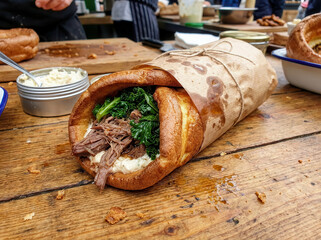 Hearty Yorkshire pudding wrap filled with shredded beef and kale, a delicious street food meal
