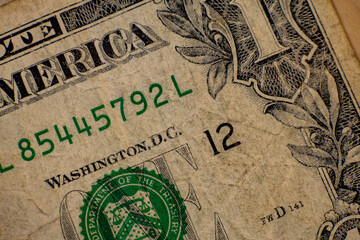 Fototapeta premium One dollar bill showing detail of serial number and design from United States currency in close up
