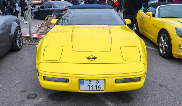 Classic yellow Chevrolet Corvette C4 iconic American sports car, known for its distinctive angular, wedge shape capturing the classic 1980s and 90s muscle car design