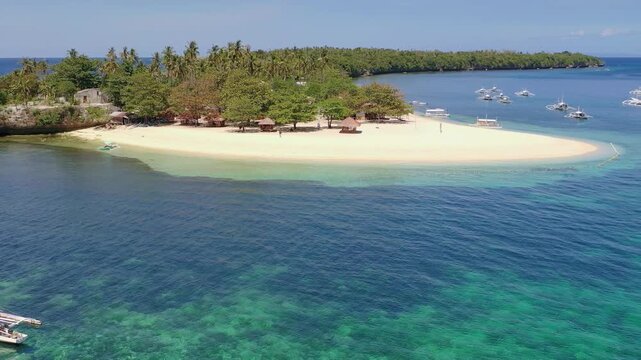 Aerial view of sandy tropical beach and small island in blue sea
