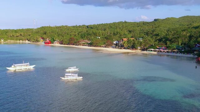 Aerial view of tropical bay with boats and green island