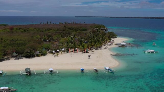 Aerial view of small tropical island with boats and white beach