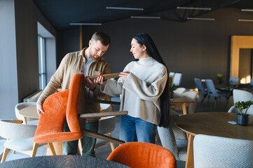 Couple choosing furniture in modern home store