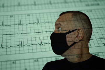 Worried adult male face over damaged electrocardiogram showing cardiac distress