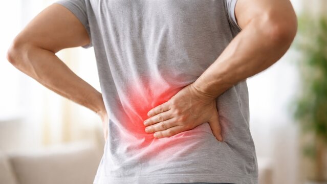 Man experiencing back pain with a red highlight on the lower back area.