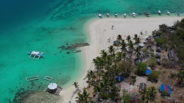 Aerial view of tropical sandbar with boats and palm trees