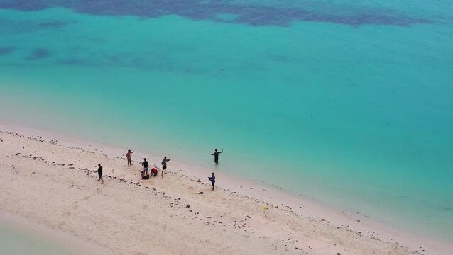 Aerial view of people in shallow tropical sea