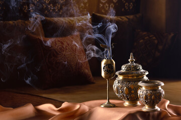An incense burner. The Ramadan holiday. Festive greeting card, invitation to the Muslim holy month of Ramadan Kareem. Dark background. Free space for copying. © Alla