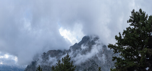 Mountain peak emerging through low clouds and mist, Crete