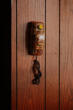 Vintage wall-mounted telephone with curly cord