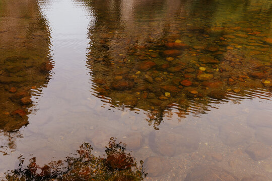 Rippling reflections in a rocky riverbed